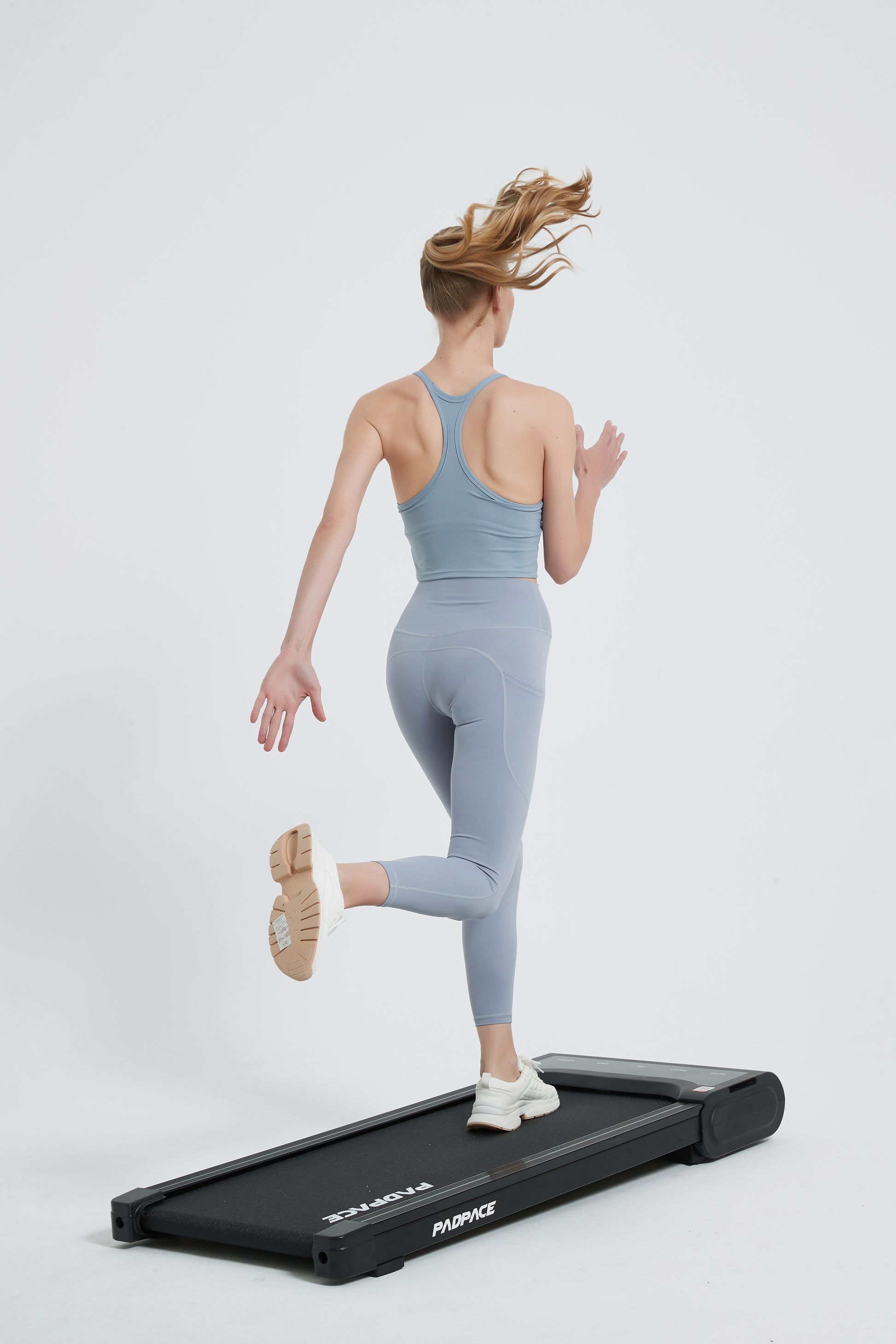 Woman running on a walking pad